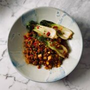 Japanese fried rice in a bowl topped with pak choi, chili and spring onion