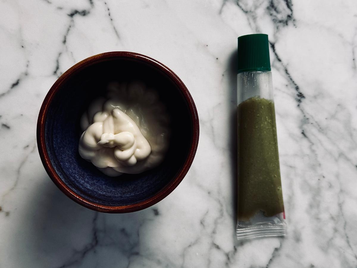 mayo in a small bowl next to a tube of wasabi paste