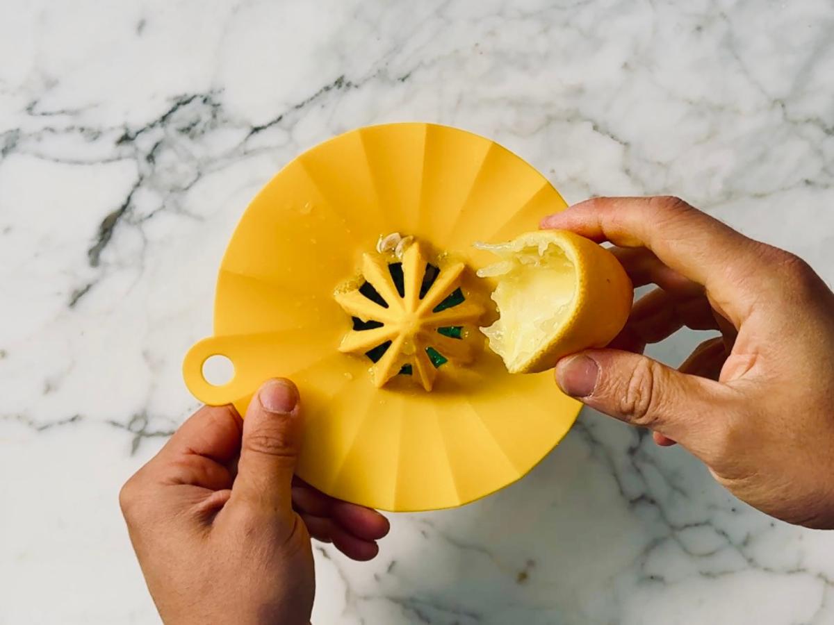 half a lemon squeezed over a manual juicer