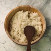 Fluffy, seasoned sushi rice cooling in a bowl, ready to be used for sushi or other dishes.