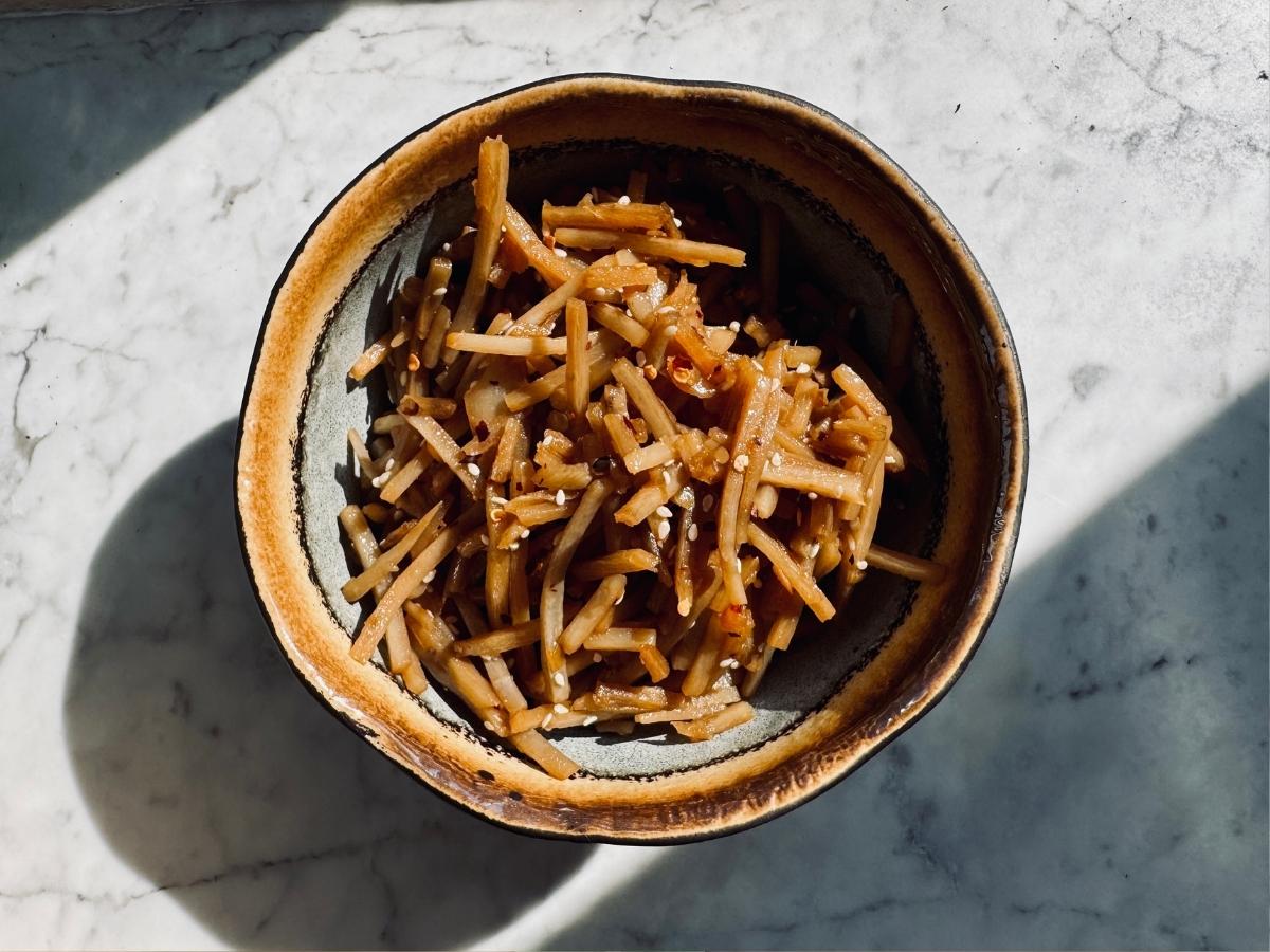 a bowl of kinpira gobo in the sunlight