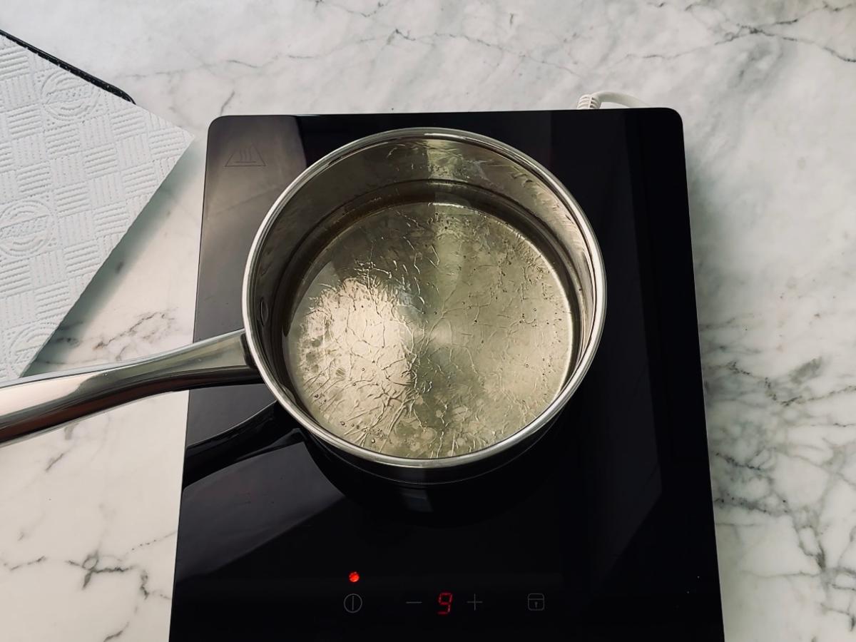 A pan filled with hot oil, ready to add a small piece of panko to test the temperature.