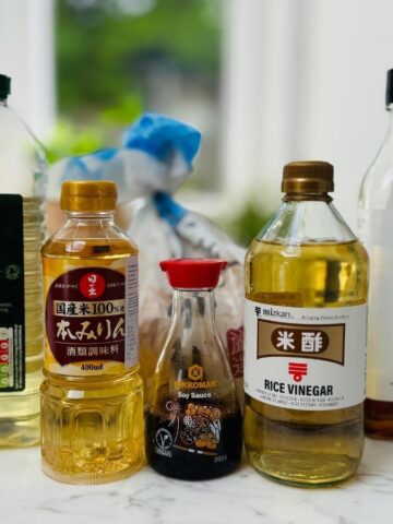 bottles of mirin, soya sauce, rice vinegar, oil and sesame oil on a marble countertop