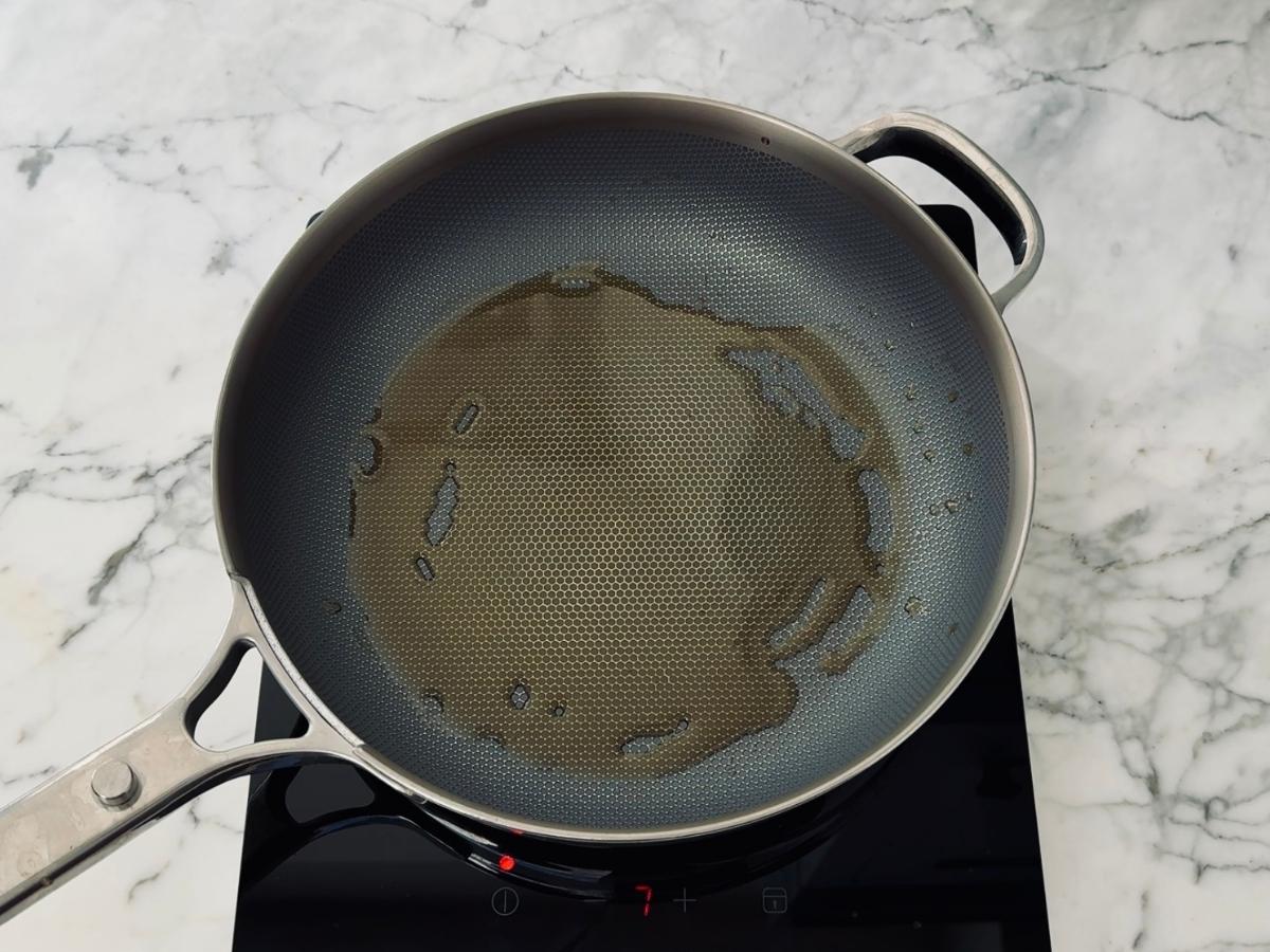 Sesame oil heating in a frying pan for 5 minute Kinpira Gobo recipe