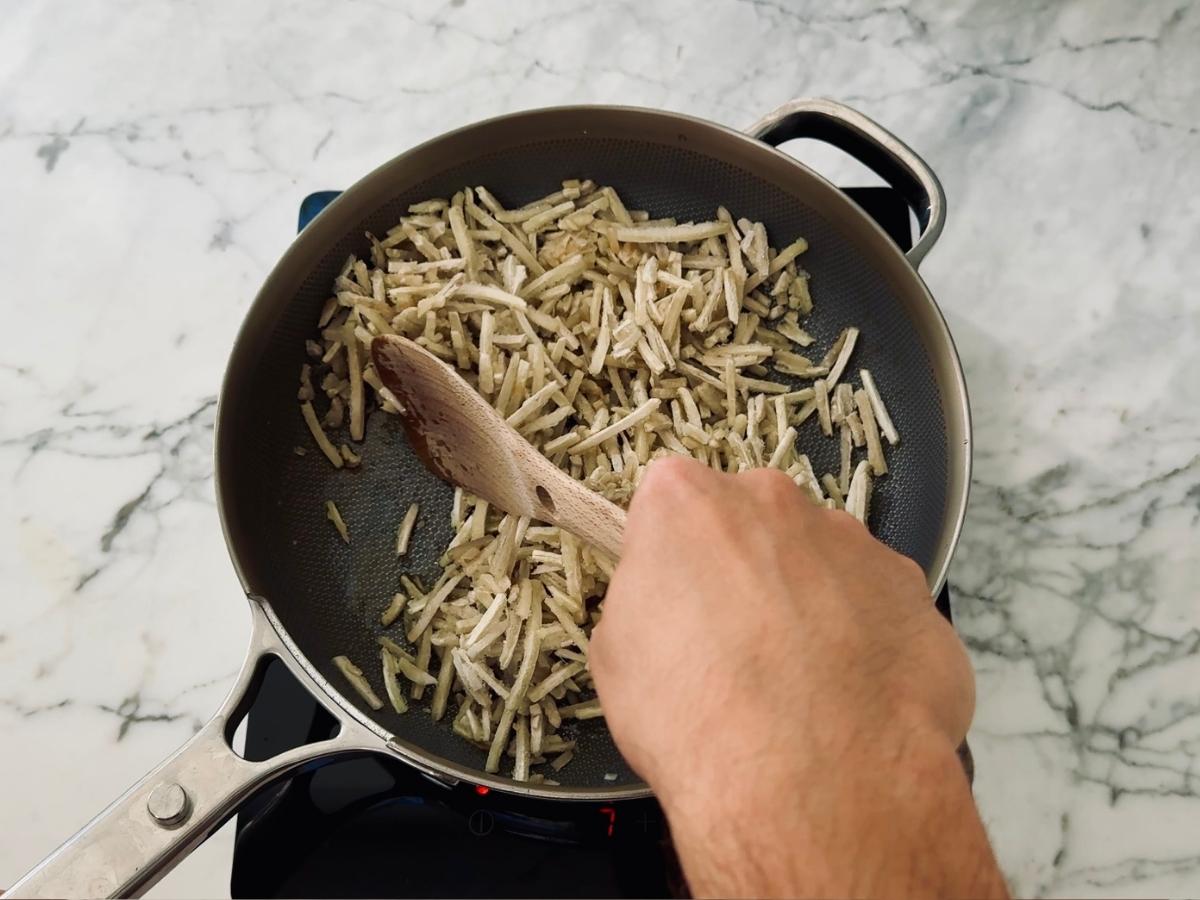 Yutaka frozen shredded burdock root added to hot sesame oil for quick Japanese Kinpira Gobo