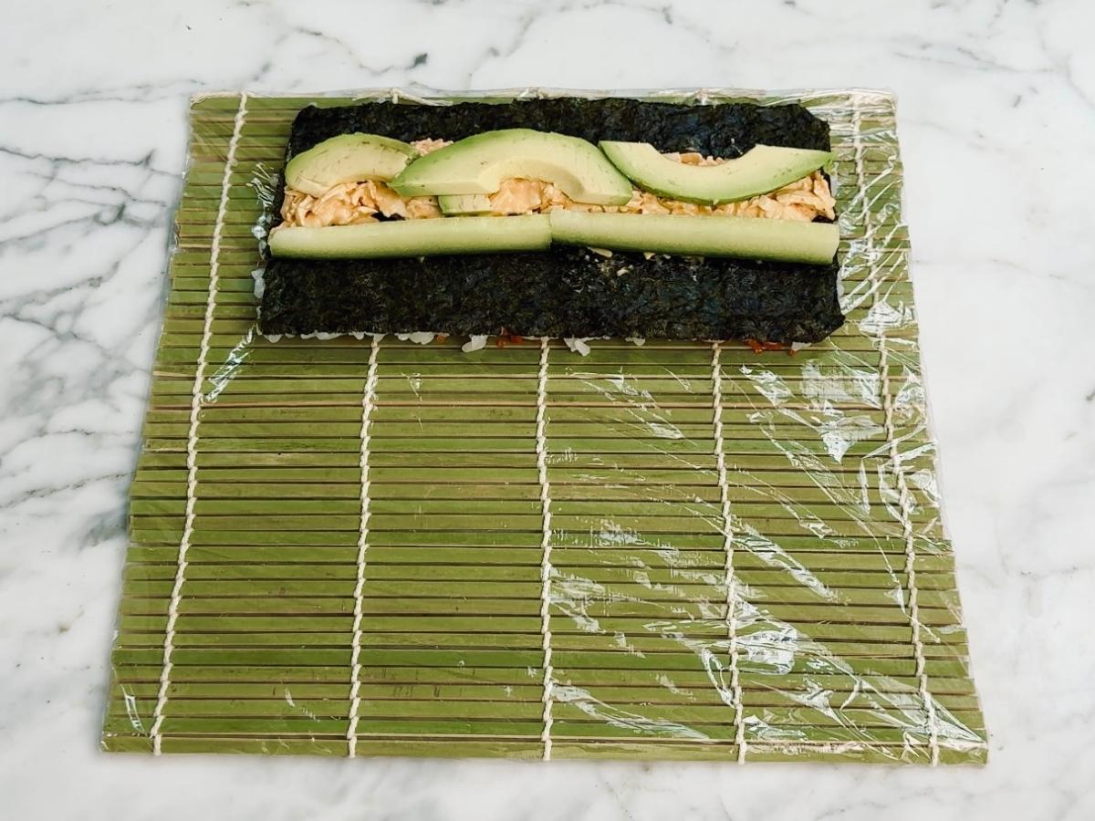 Cucumber sticks and avocado slices placed neatly over the tofu filling.