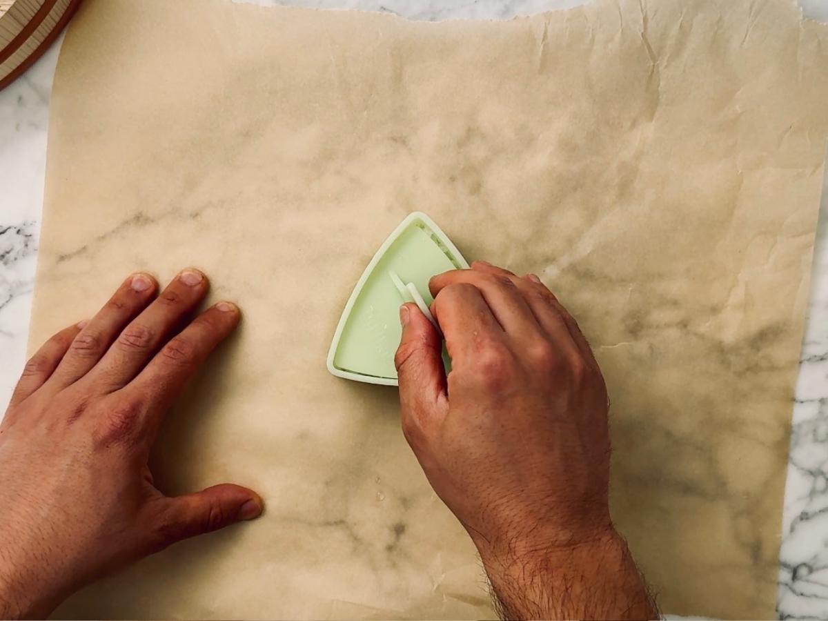 Pressing down on rice in an onigiri mold.