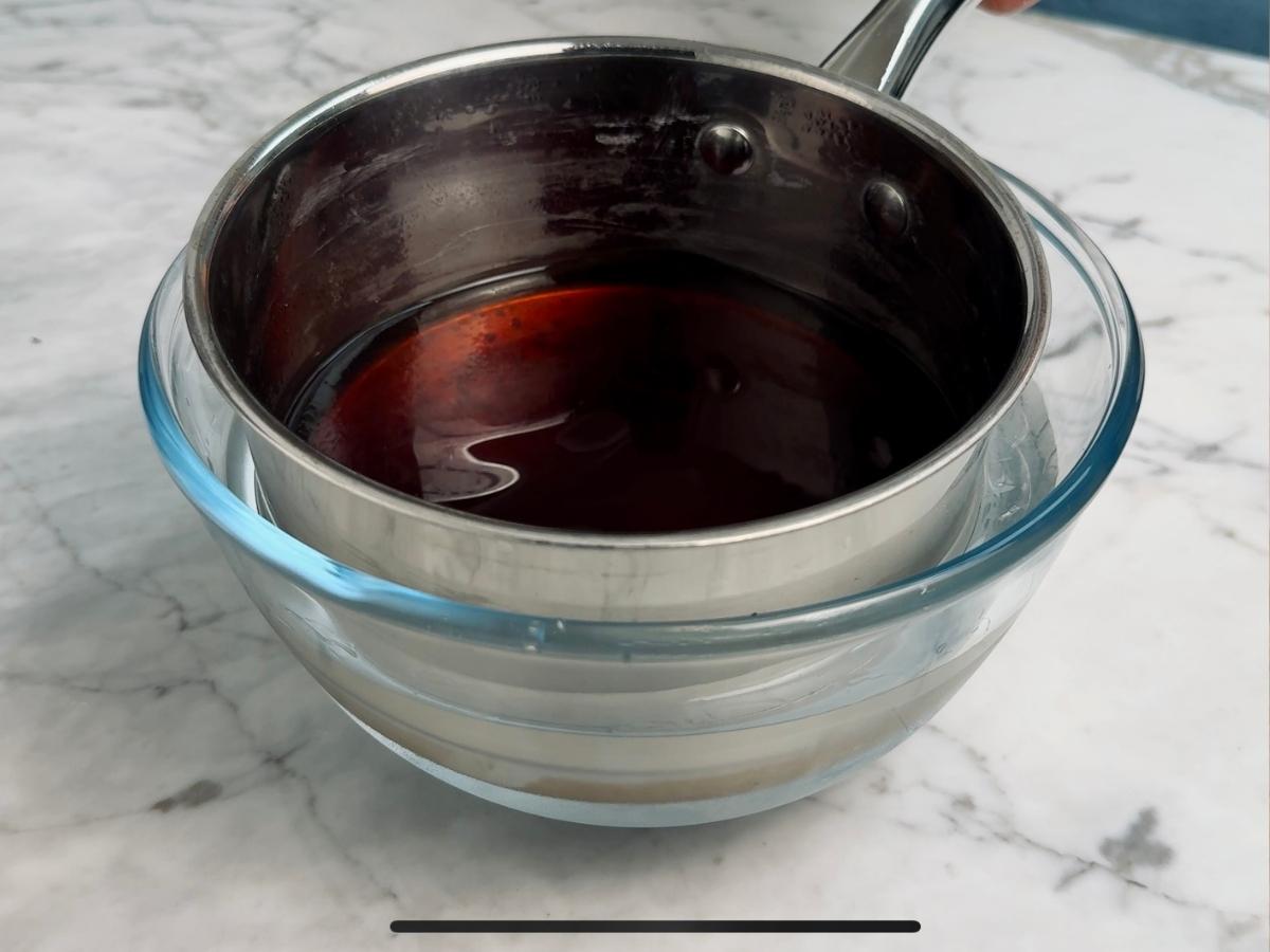Small saucepan placed in a bowl of ice water to rapidly cool the sauce.