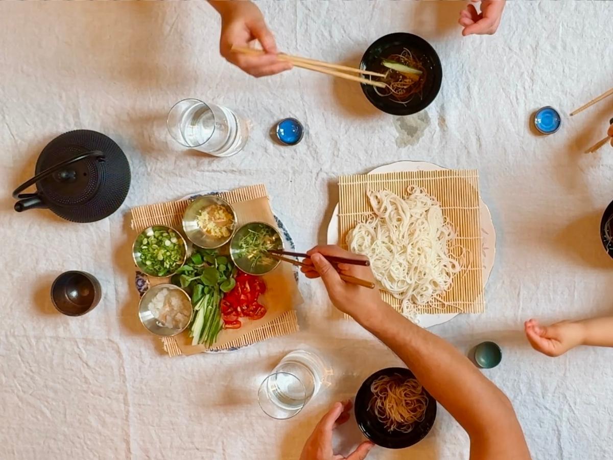 birds-eye view of dining table laid out with somen, toppings and dipping bowls