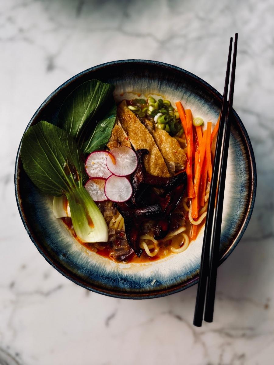 birdseye view of bowled up vegan spicy ramen with toppings
