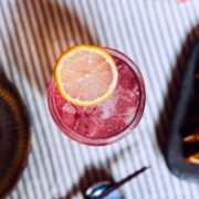 Sake fizz cocktail garnished with lemon slice