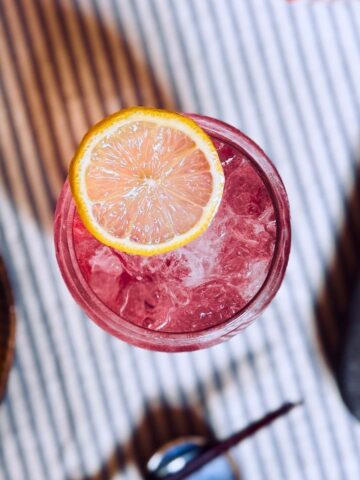 birdseye view of the sake fizz cocktail garnished with lemon slice