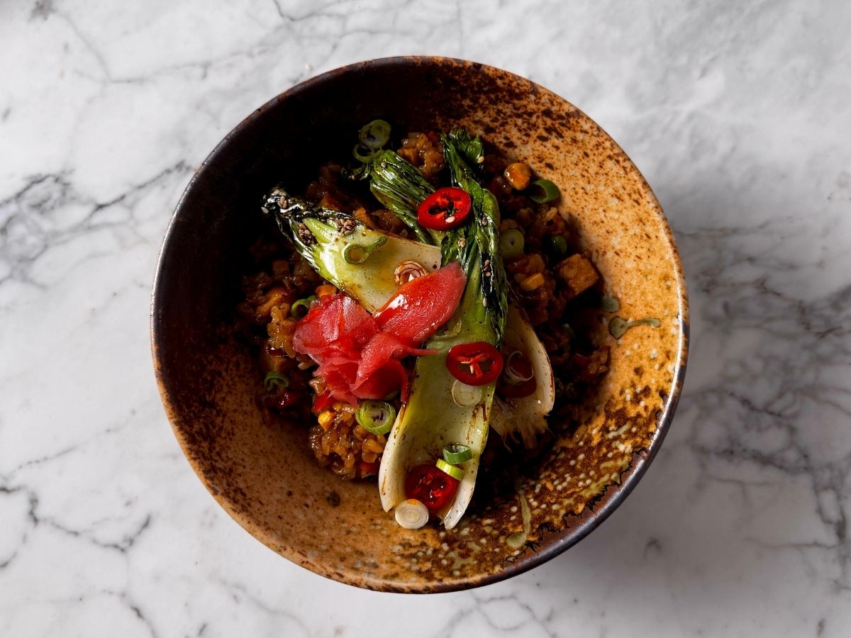 Finished seared vegan bok choy recipe, garnished with sliced chili, green onions and Japanese ginger pickle