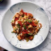 Yaki udon noodles garnished with pickled ginger and spring onions