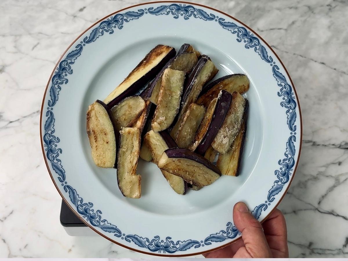 fried eggplant pieces on a plate - resting before further cooking