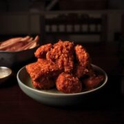 Vegan fried chicken tofu piled on a small plate