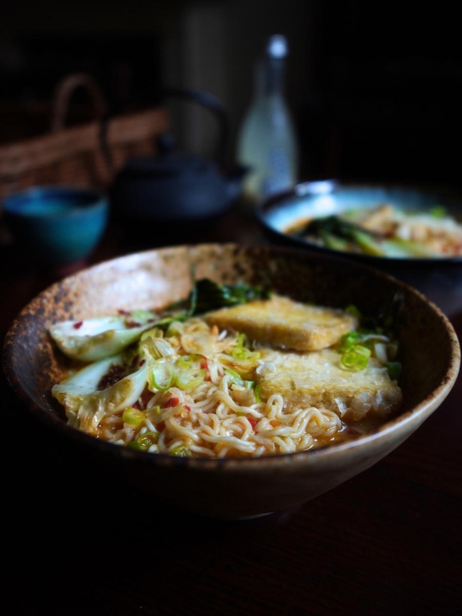 yuzu ramen pictured from the side on a wooden table