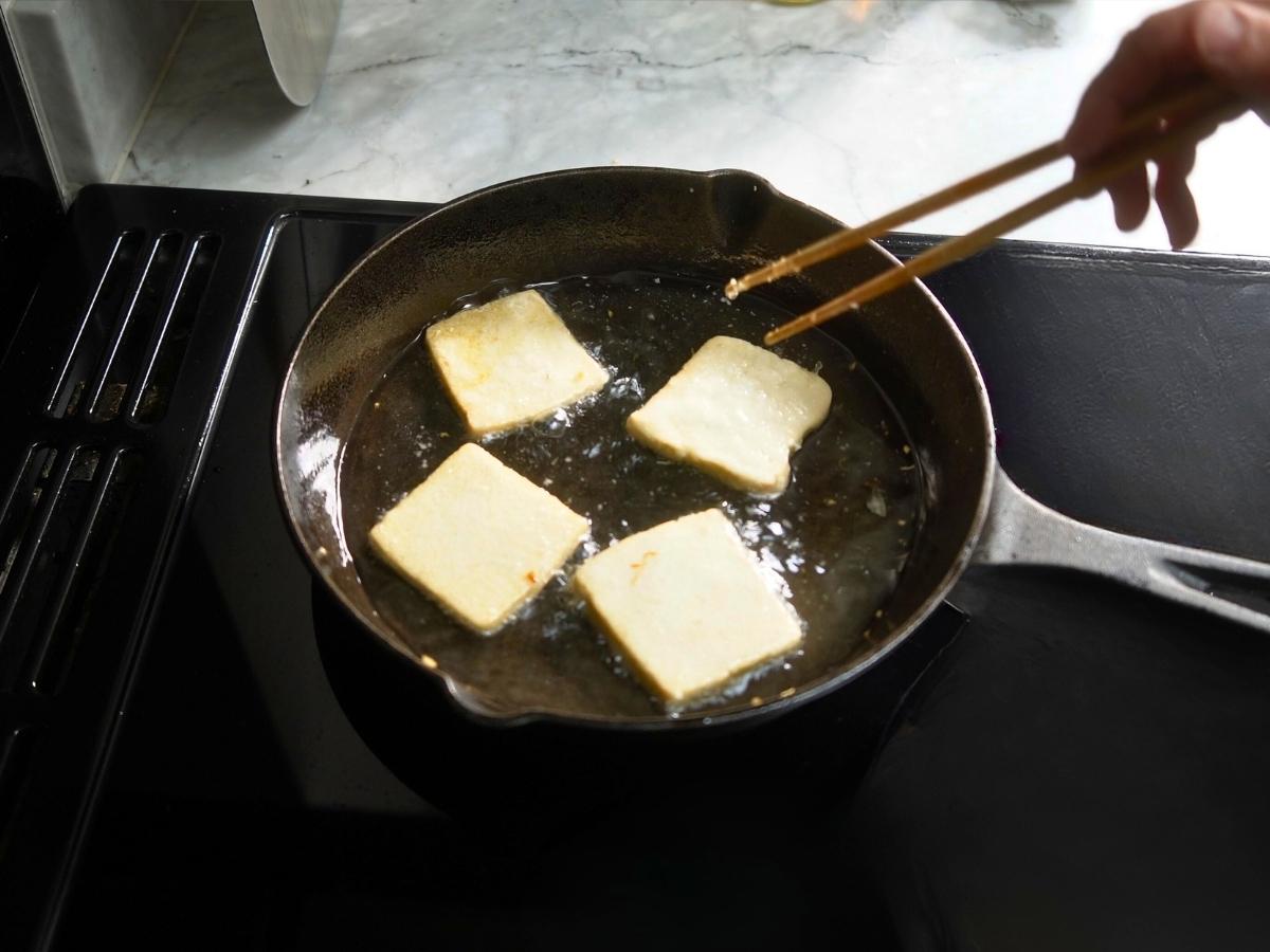 tofu topping being shallow fried 