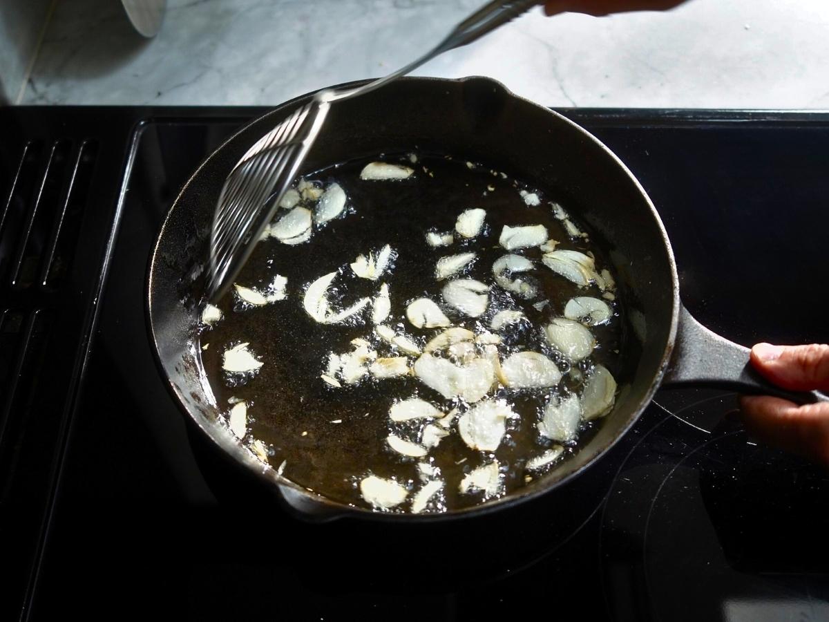 garlic being shallow fried in a pan