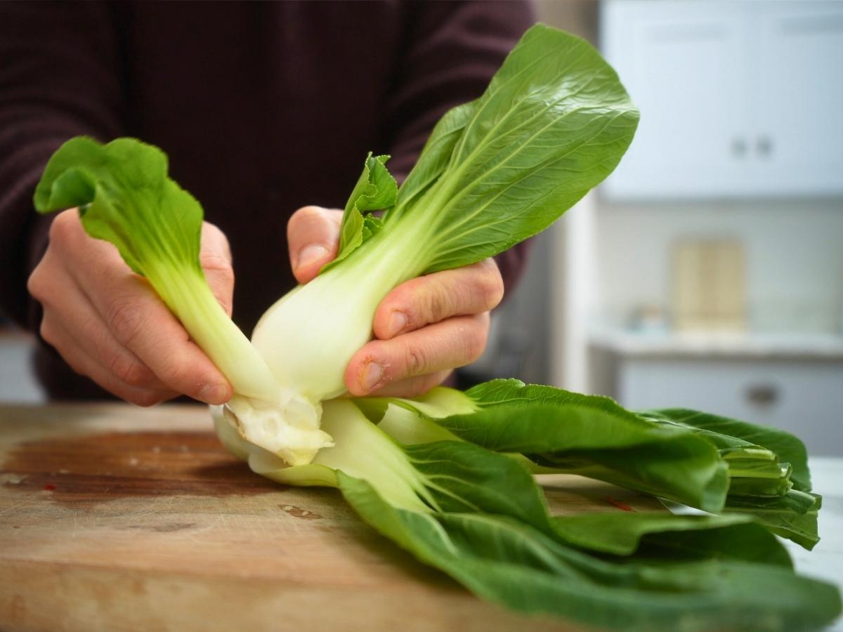 Leaves being plucked off bok choy
