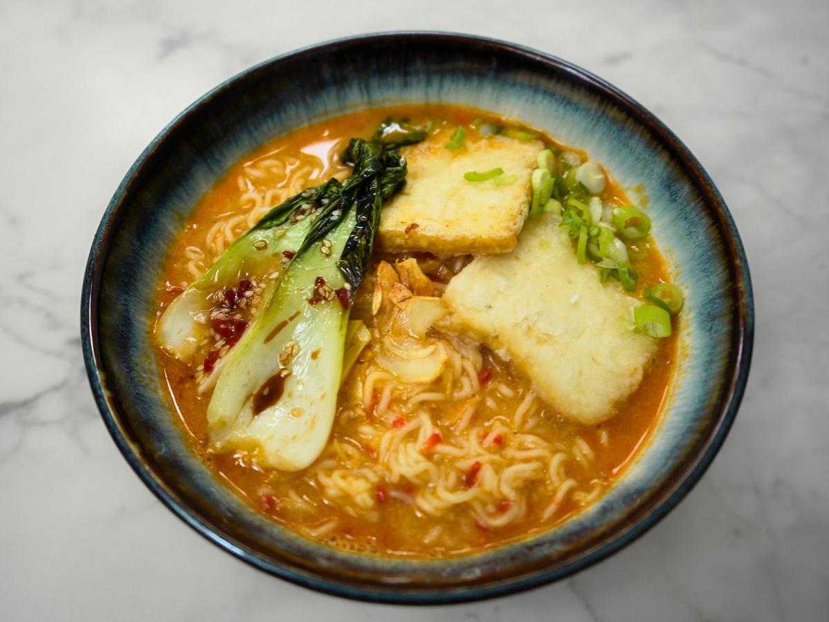 completed ramen bowl, toppings placed on top and garnished with green onions