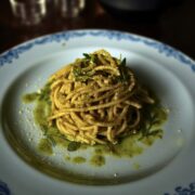 Miso walnut pesto spaghetti on a plate garnished with thyme