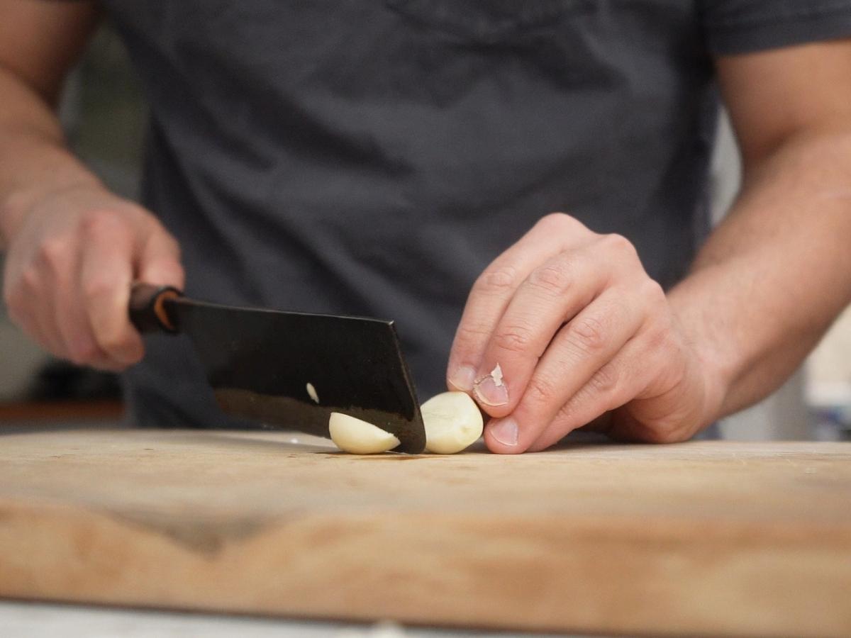 halving a garlic clove for homemade rayu
