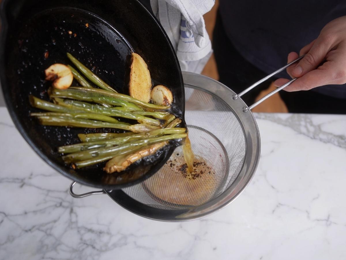 straining hot oil into ichimi chili mixture for rayu

